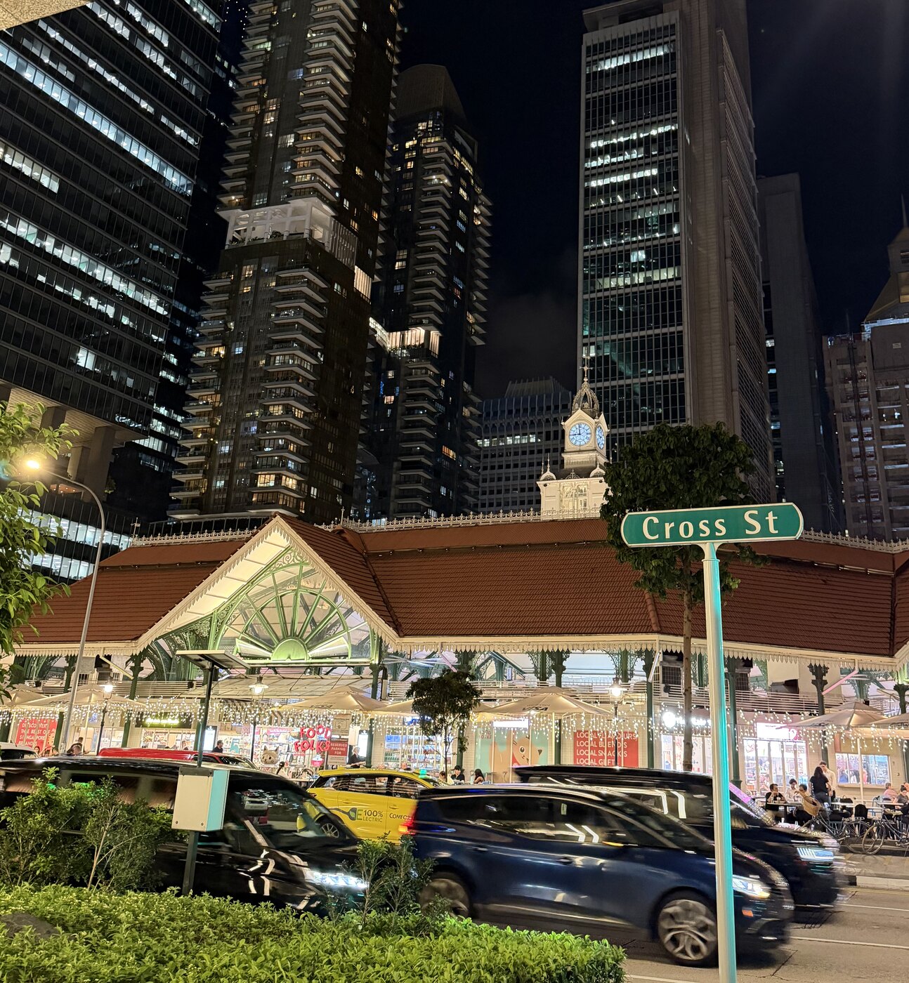 Singapore skyline at night with Lau Pa Sat in the foreground